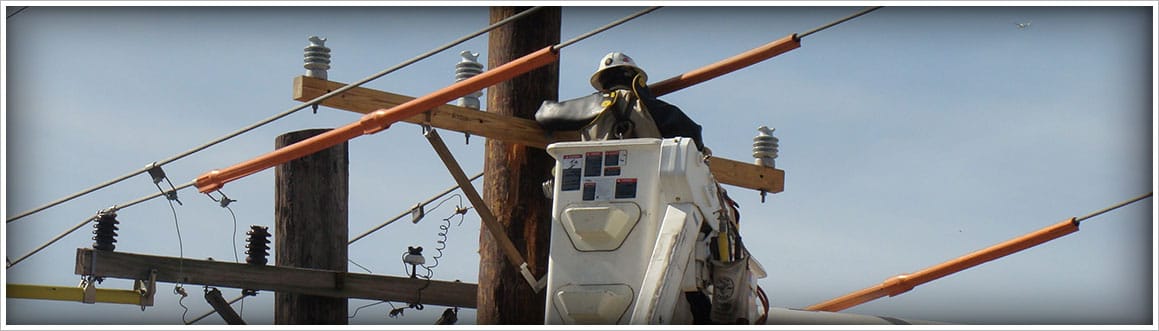 Image of a Lineman on an electrical pole doing work